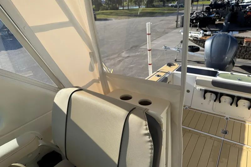 Slide: The Image of Interior view of a 2007 Pursuit OS 335 Offshore boat, featuring seating and cup holders. - 18