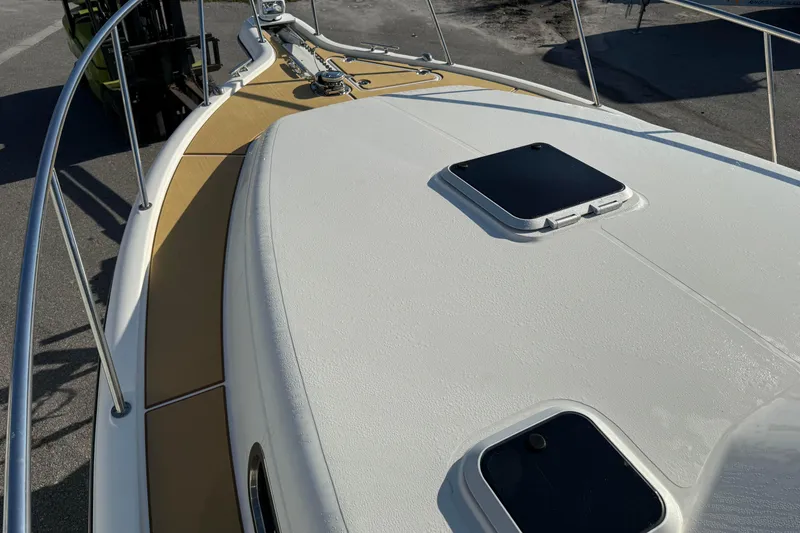 Slide: The Image of 2007 Pursuit OS 335 Offshore boat deck with hatches and railing. - 23