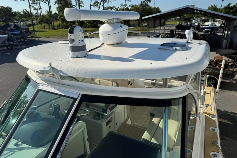 Slide: The Image of 2007 Pursuit OS 335 Offshore boat with radar equipment, docked in a marina. - 25