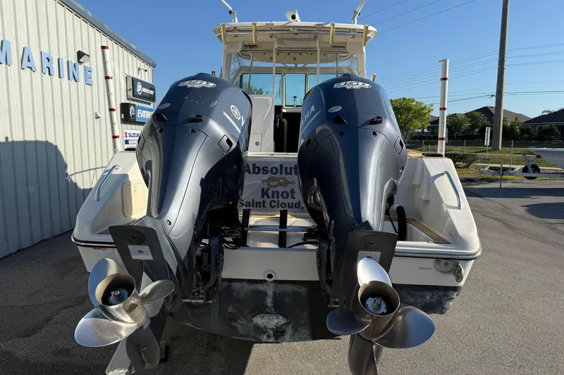 Slide: The Image of 2007 Pursuit OS 335 Offshore boat with dual outboard engines, docked at a marina. - 3