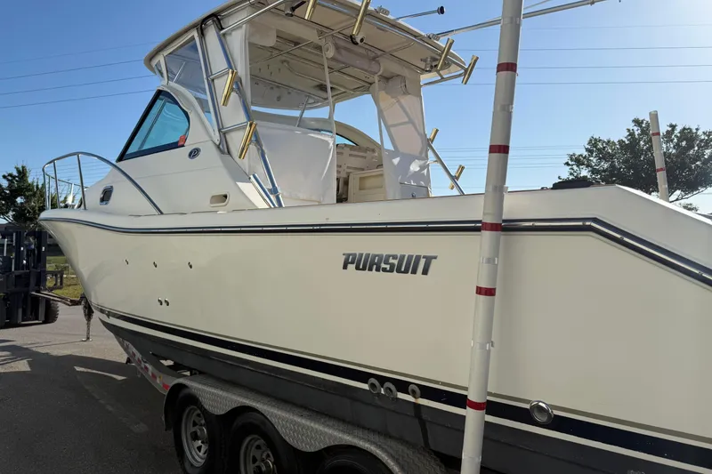 Slide: The Image of 2007 Pursuit OS 335 Offshore boat on trailer, side view in sunlight. - 5