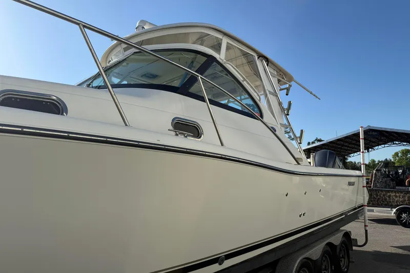Slide: The Image of 2007 Pursuit OS 335 Offshore boat on trailer under clear blue sky. - 6