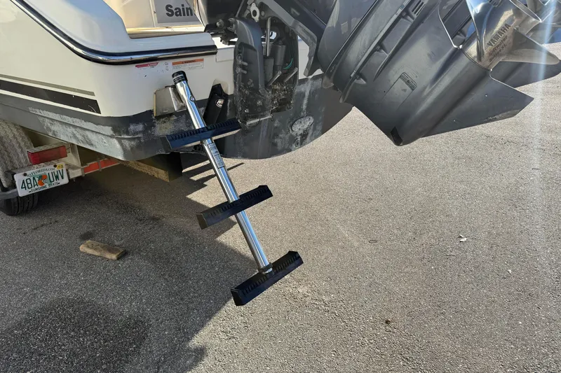 Slide: The Image of 2007 Pursuit OS 335 Offshore boat with ladder and outboard motor on trailer. - 9