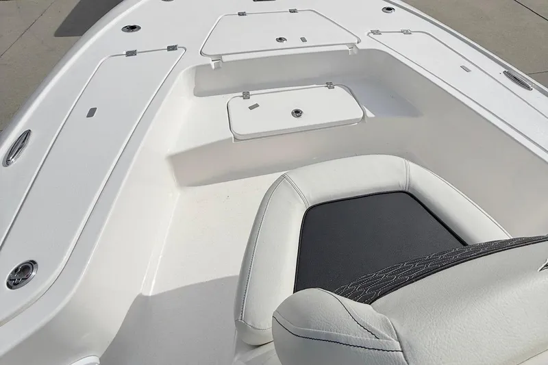 Slide: The Image of 2024 Tidewater 2110 Bay Max boat interior with white seating and storage compartments. - 4