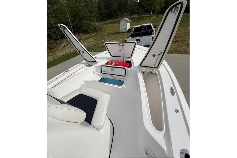 Slide: The Image of 2024 Tidewater 2110 Bay Max boat with open storage compartments and seating. - 5