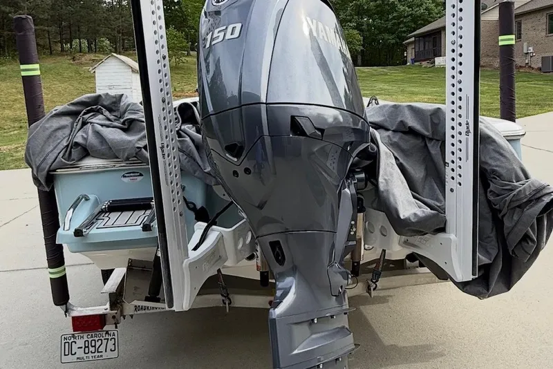 Slide: The Image of 2024 Tidewater 2110 Bay Max boat with Yamaha 150 engine, parked on driveway. - 7