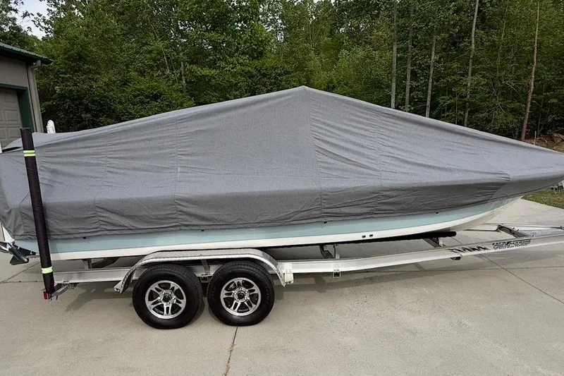 Slide: The Image of 2024 Tidewater 2110 Bay Max boat covered on trailer, parked outdoors. - 9