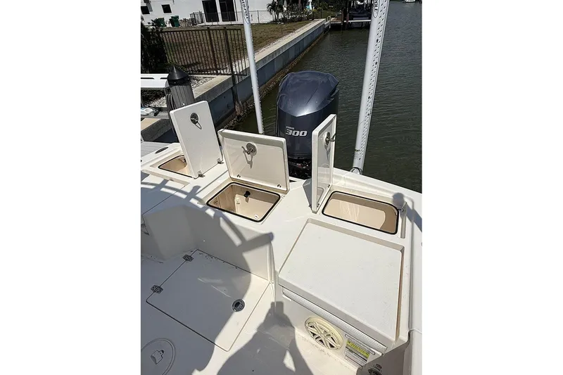 Slide: The Image of 2020 Pathfinder 2500 Hybrid boat with open storage compartments and Yamaha 300 engine. - 11