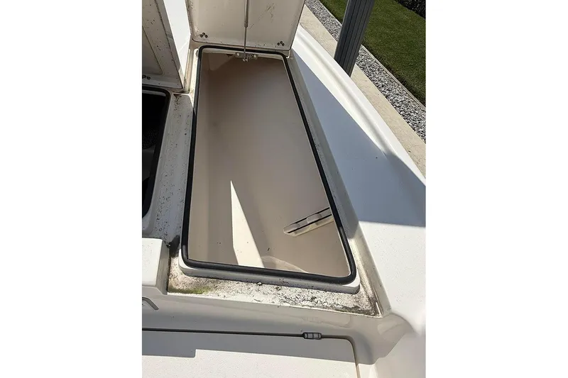 Slide: The Image of Open storage compartment on a 2020 Pathfinder 2500 Hybrid boat, showing interior details. - 16