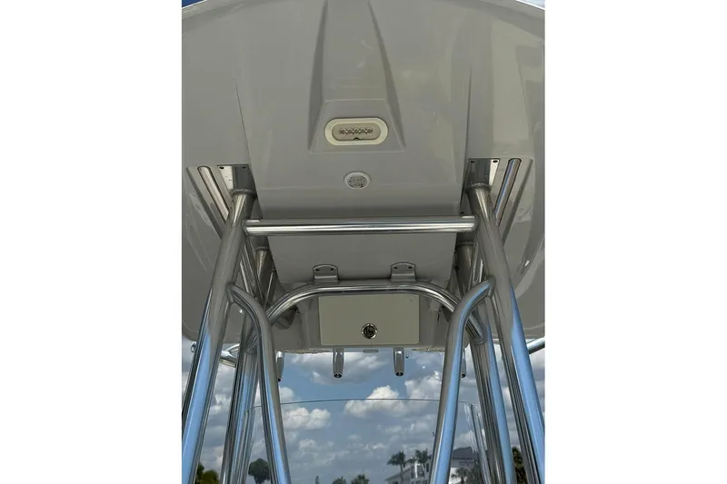 Slide: The Image of 2020 Pathfinder 2500 Hybrid boat T-top with stainless steel frame and clear sky background. - 21
