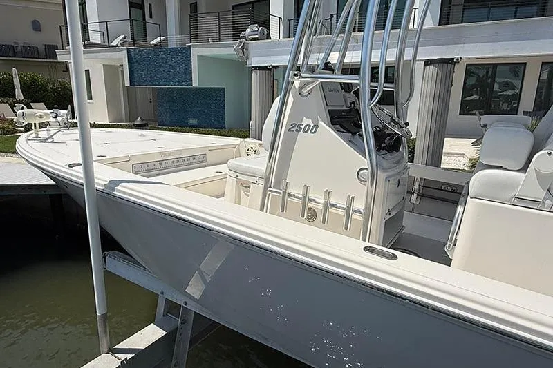 Slide: The Image of 2020 Pathfinder 2500 Hybrid boat docked near modern waterfront home. - 3