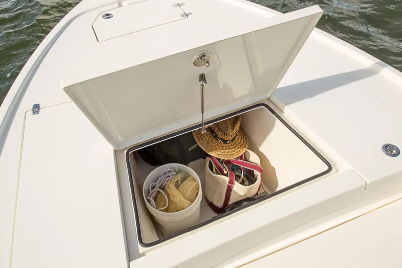Slide: The Image of Manufacturer Provided Image: Storage compartment on a 2020 Pathfinder 2500 Hybrid boat with bags and hats. - 33
