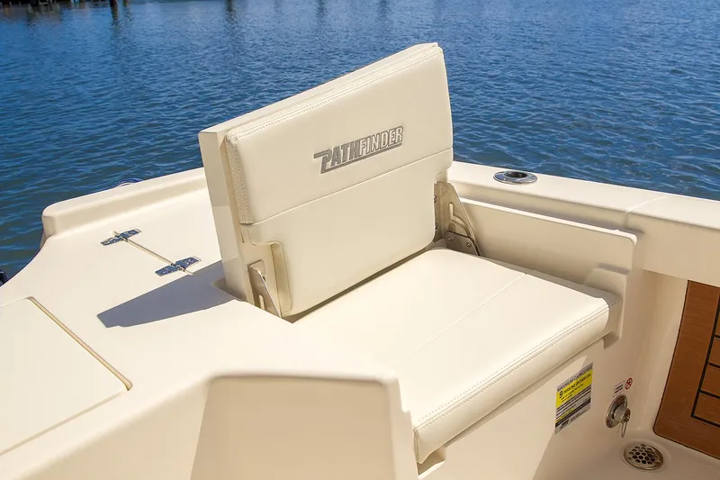 Slide: The Image of Manufacturer Provided Image: 2020 Pathfinder 2500 Hybrid boat seat with logo, near water. - 40