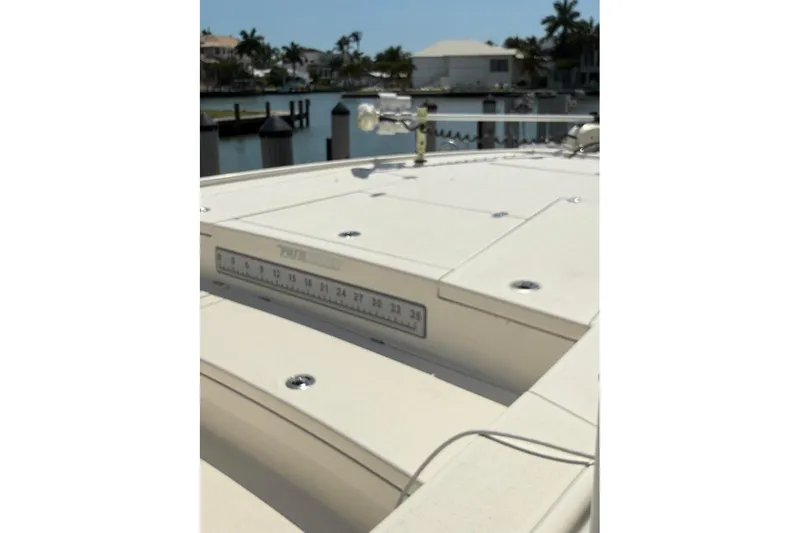 Slide: The Image of 2020 Pathfinder 2500 Hybrid boat deck with ruler, docked near waterfront homes. - 5