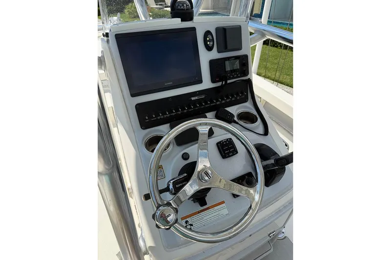 Slide: The Image of Control panel of 2020 Pathfinder 2500 Hybrid boat with steering wheel and navigation equipment. - 6