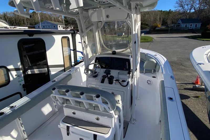 Slide: The Image of 2019 Sportsman Open 232 Center Console boat interior with steering wheel and seating. - 10