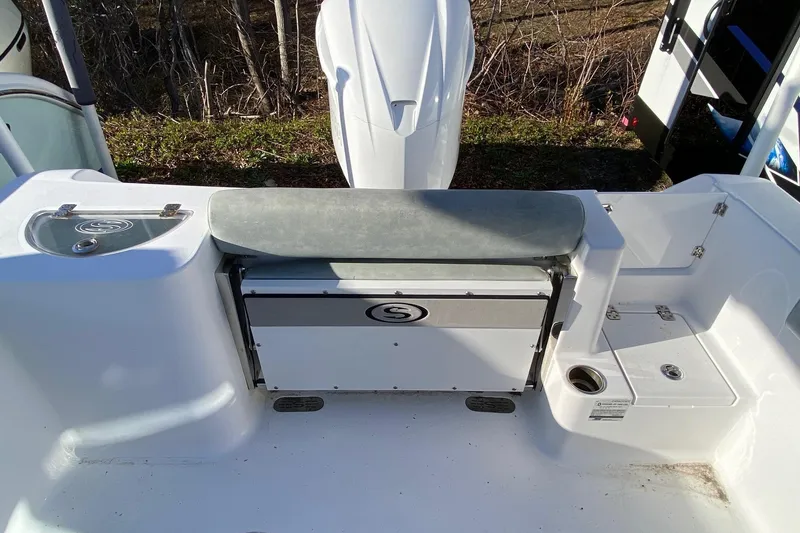 Slide: The Image of 2019 Sportsman Open 232 Center Console boat interior with seating and storage. - 12