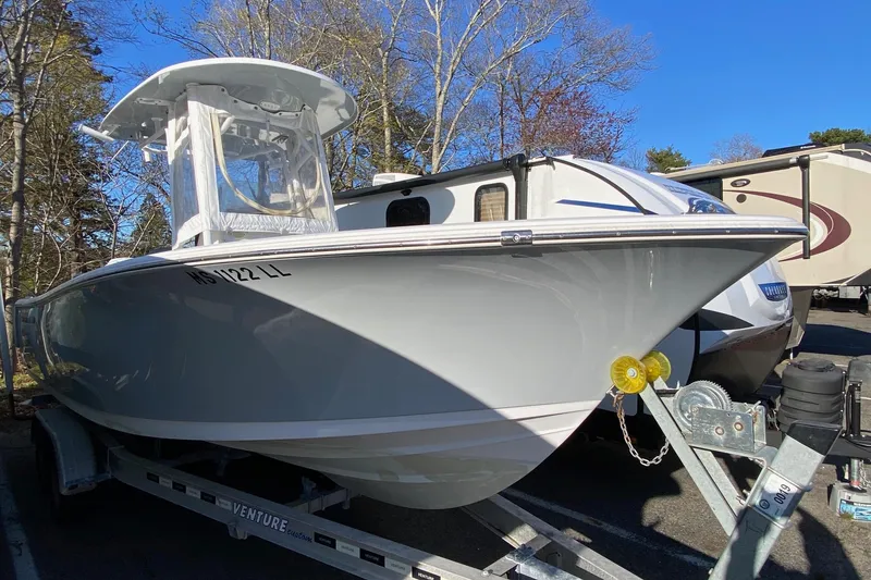 Slide: The Image of 2019 Sportsman Open 232 Center Console boat on trailer, parked outdoors. - 19