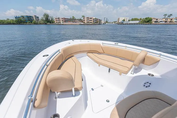 Slide: The Image of Manufacturer Provided Image: 2019 Sportsman Open 232 Center Console boat with tan seating on the water. - 21