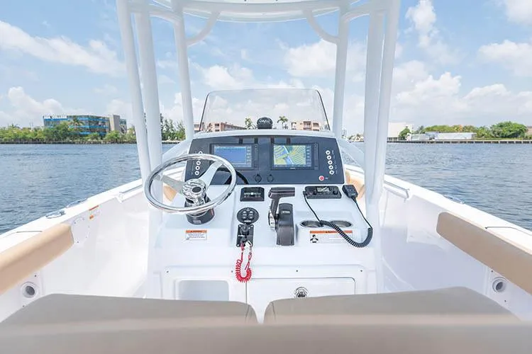 Slide: The Image of Manufacturer Provided Image: 2019 Sportsman Open 232 Center Console boat dashboard with steering wheel and navigation system. - 27