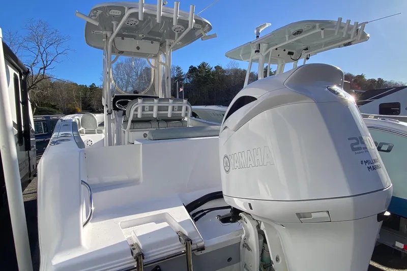 Slide: The Image of 2019 Sportsman Open 232 Center Console boat with Yamaha engine, docked outdoors. - 3