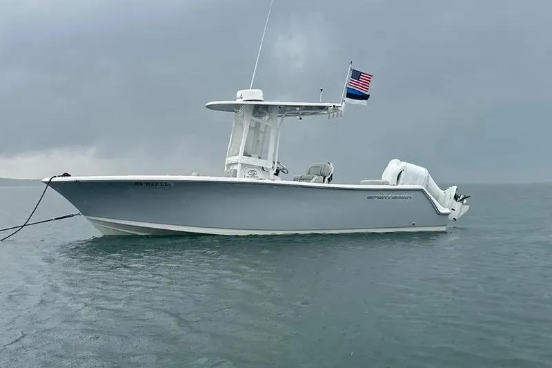 Slide: The Image of 2019 Sportsman Open 232 Center Console boat on calm water, overcast sky. - 4