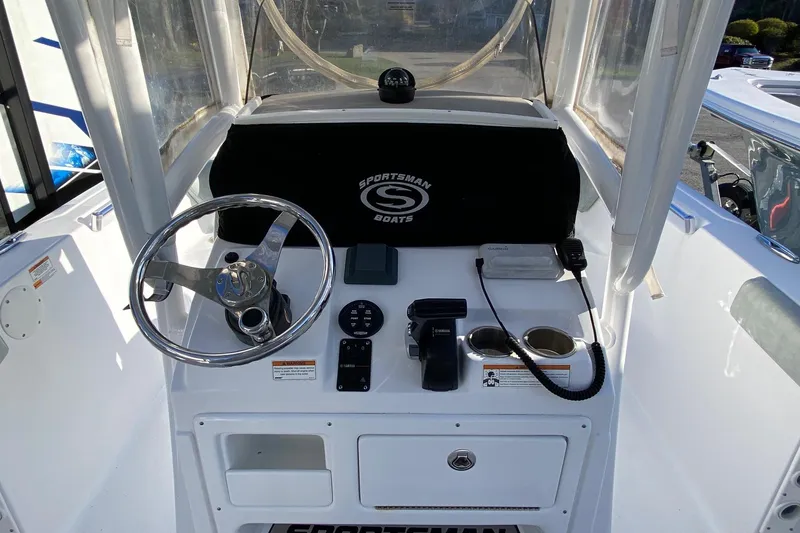 Slide: The Image of 2019 Sportsman Open 232 Center Console boat dashboard with steering wheel and controls. - 6