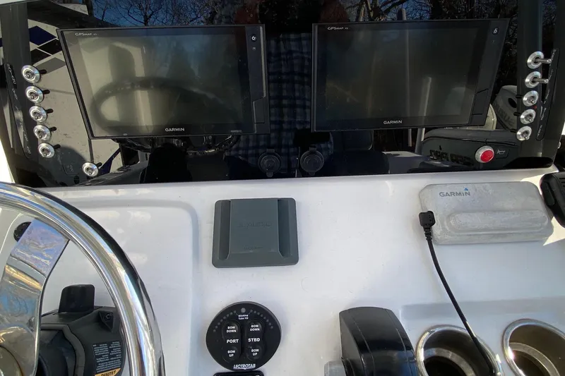 Slide: The Image of 2019 Sportsman Open 232 Center Console dashboard with Garmin displays and JL Audio system. - 7