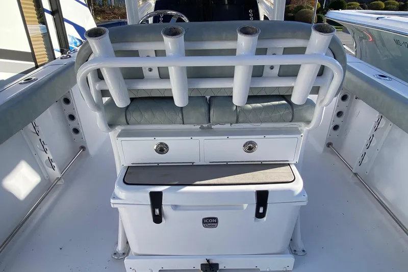 Slide: The Image of 2019 Sportsman Open 232 Center Console boat interior with rod holders and storage. - 9