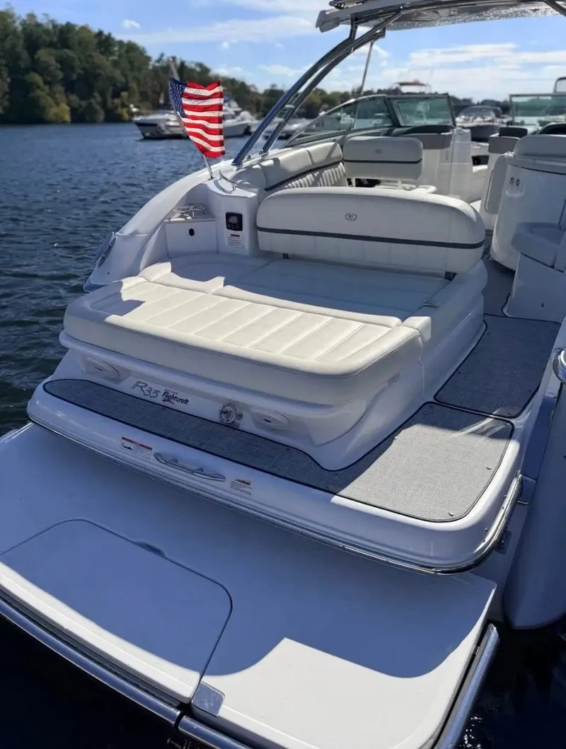 Slide: The Image of 2020 Cobalt R35 boat on a serene lake with American flag. - 11