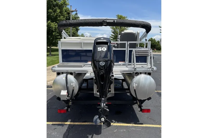 Slide: The Image of 2026 Sun Tracker Bass Buggy 16 XL Select pontoon boat with Mercury 50 engine, rear view. - 7