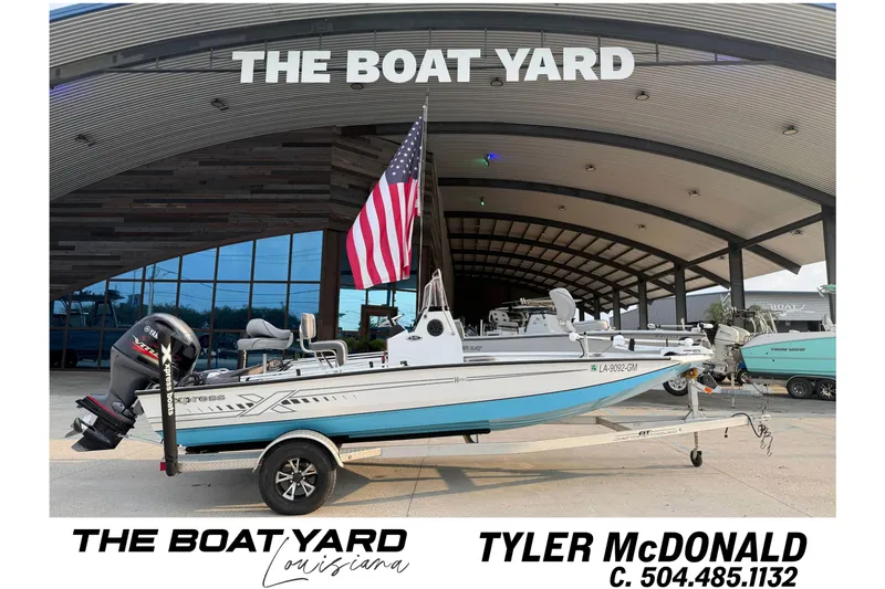 The Image of 2022 Xpress H20B Bay boat at The Boat Yard, Louisiana, with American flag. - 1