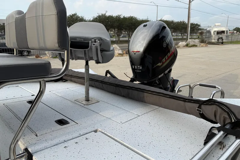 Slide: The Image of 2022 Xpress H20B Bay boat with Yamaha 115 engine and seating area. - 10
