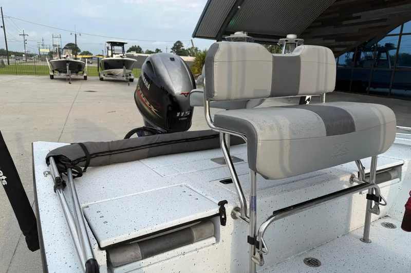 Slide: The Image of 2022 Xpress H20B Bay boat with Yamaha 115 engine, featuring cushioned seating. - 12