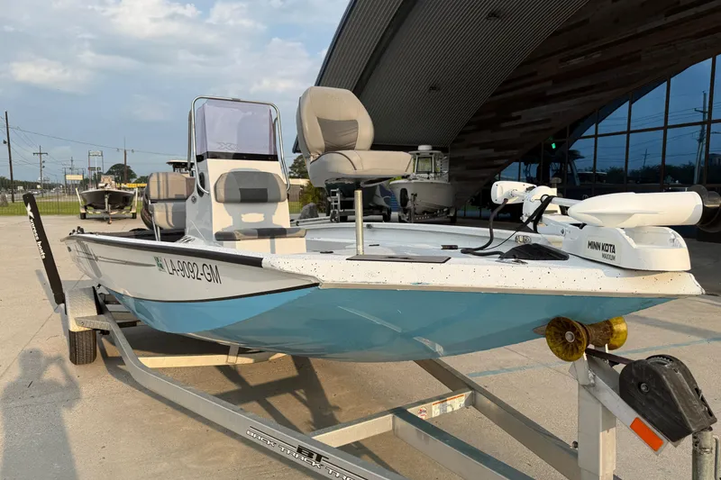 Slide: The Image of 2022 Xpress H20B Bay boat on trailer, featuring Minn Kota trolling motor. - 3