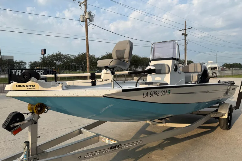 Slide: The Image of 2022 Xpress H20B Bay boat on trailer, featuring Minn Kota Maxxum motor. - 4