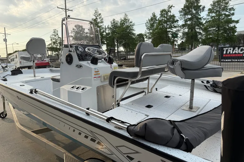 Slide: The Image of 2022 Xpress H20B Bay boat with seating and console, parked outdoors. - 7