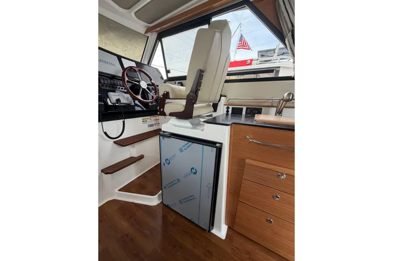 Slide: The Image of Interior of 2026 Cutwater C-288 CB boat with helm, steering wheel, and cabinetry. - 13