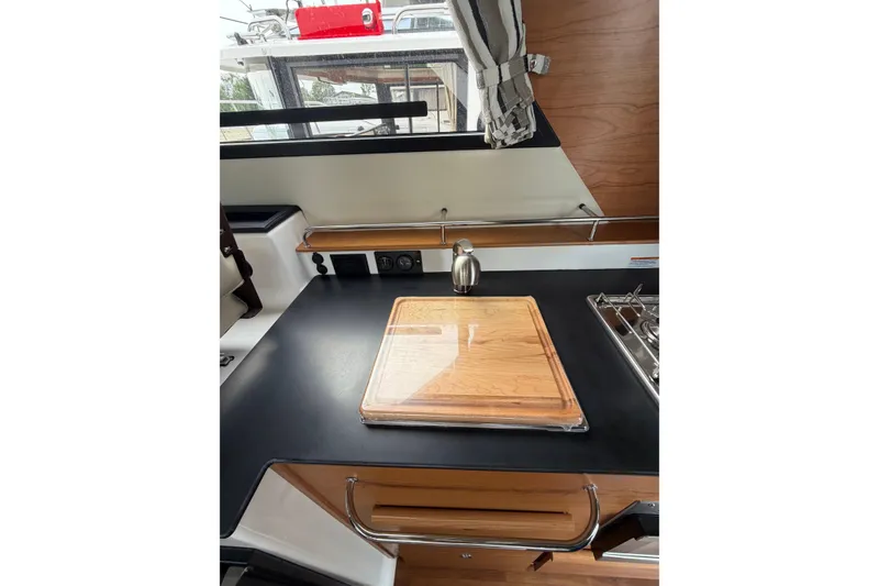 Slide: The Image of 2026 Cutwater C-288 CB boat kitchen with cutting board and stove. - 14