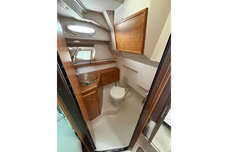Slide: The Image of 2026 Cutwater C-288 CB boat interior bathroom with wooden cabinetry and modern fixtures. - 19