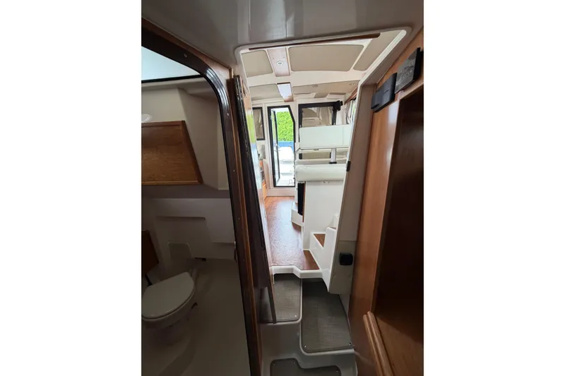 Slide: The Image of Interior view of 2026 Cutwater C-288 CB boat, featuring modern design and wooden accents. - 20