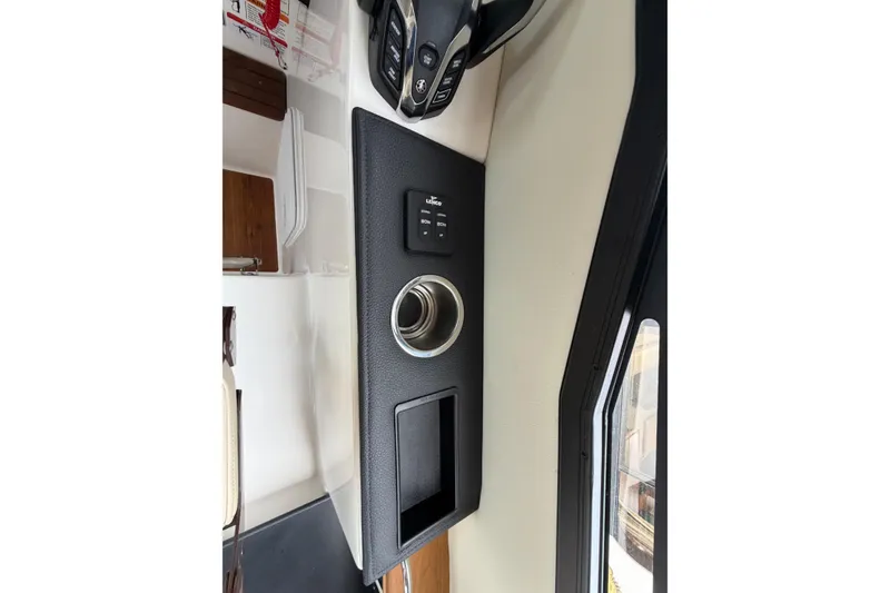 Slide: The Image of 2026 Cutwater C-288 CB interior dashboard with control panel and cup holder. - 23