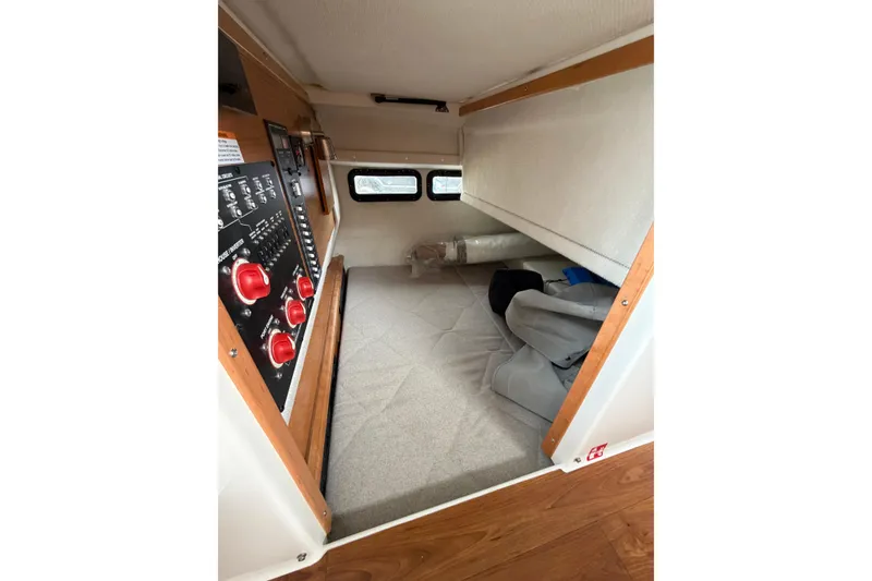 Slide: The Image of Interior cabin view of 2026 Cutwater C-288 CB boat, featuring control panel and cozy sleeping area. - 24