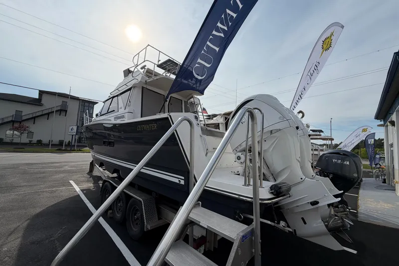 Slide: The Image of 2026 Cutwater C-288 CB boat displayed outdoors with flags and Yamaha engine. - 3