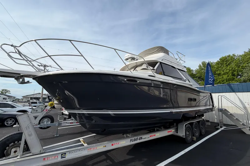 Slide: The Image of 2026 Cutwater C-288 CB boat on trailer, displayed outdoors under clear sky. - 4