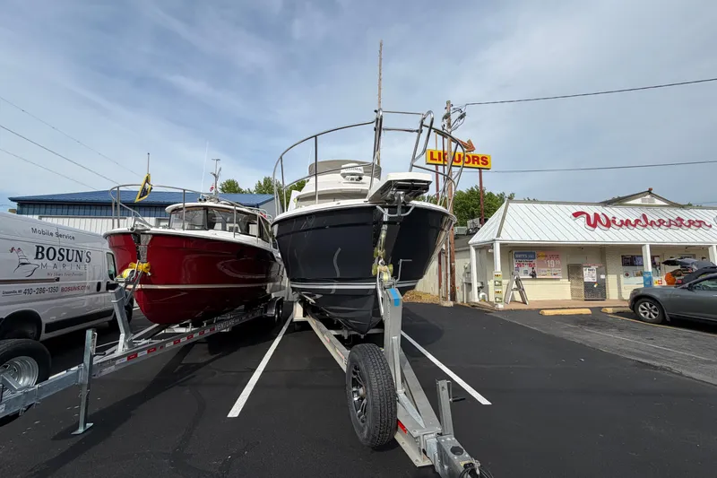 Slide: The Image of 2026 Cutwater C-288 CB boats on trailers in parking lot near Winchester store. - 5