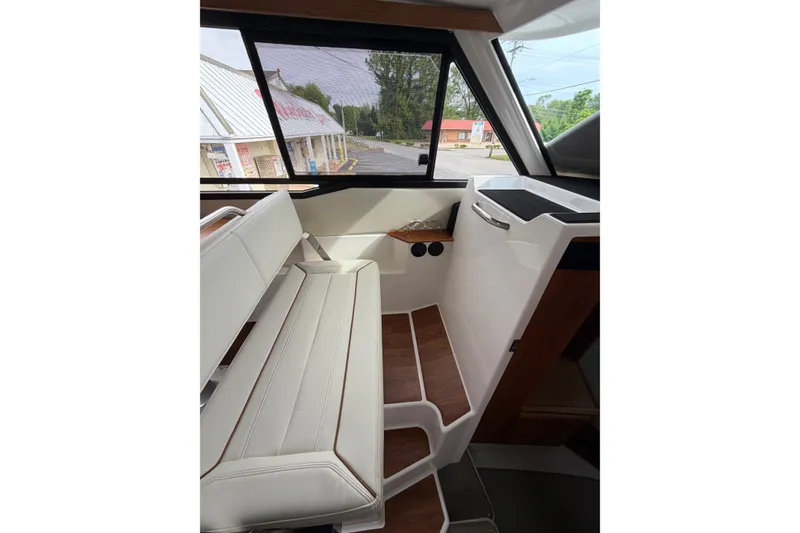 Slide: The Image of 2026 Cutwater C-288 CB interior with white seating and wood accents. - 6