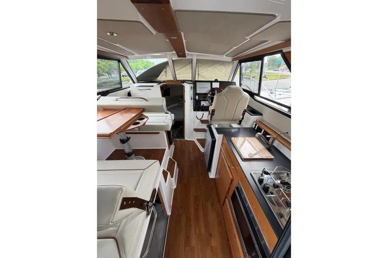 Slide: The Image of Interior of 2026 Cutwater C-288 CB boat with modern kitchen and seating area. - 7