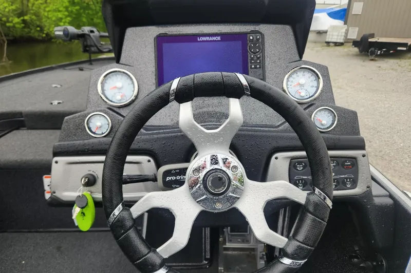 Slide: The Image of Steering wheel and dashboard of a 2022 Nitro Z19 Pro boat with gauges and controls. - 8