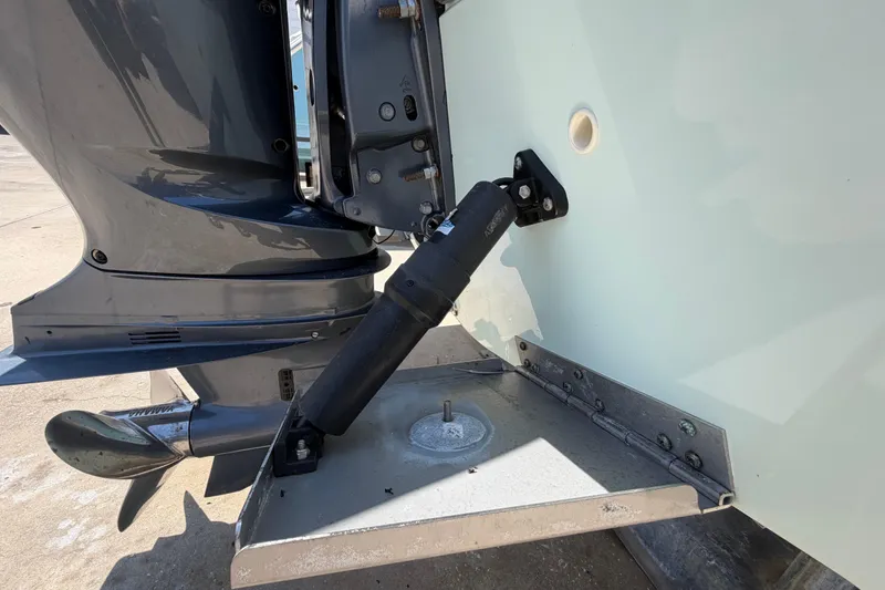Slide: The Image of Outboard motor and trim tab on a 2016 Century 2301 Center Console boat. - 11